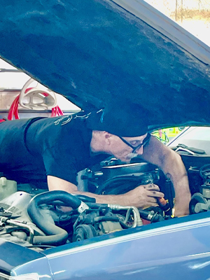 Rick Palmer working on vehicle's engine | Innovative Auto Works